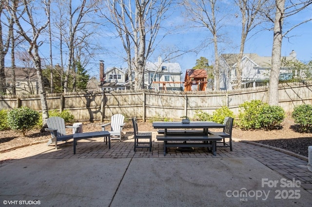 view of patio featuring outdoor dining area and a fenced backyard