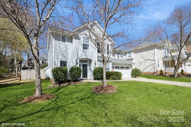 view of front facade with driveway, a front lawn, an attached garage, and fence