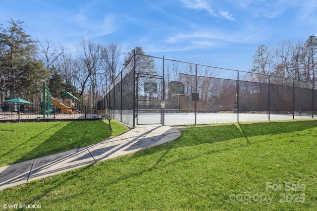 view of basketball court featuring a lawn, a gate, fence, and playground community