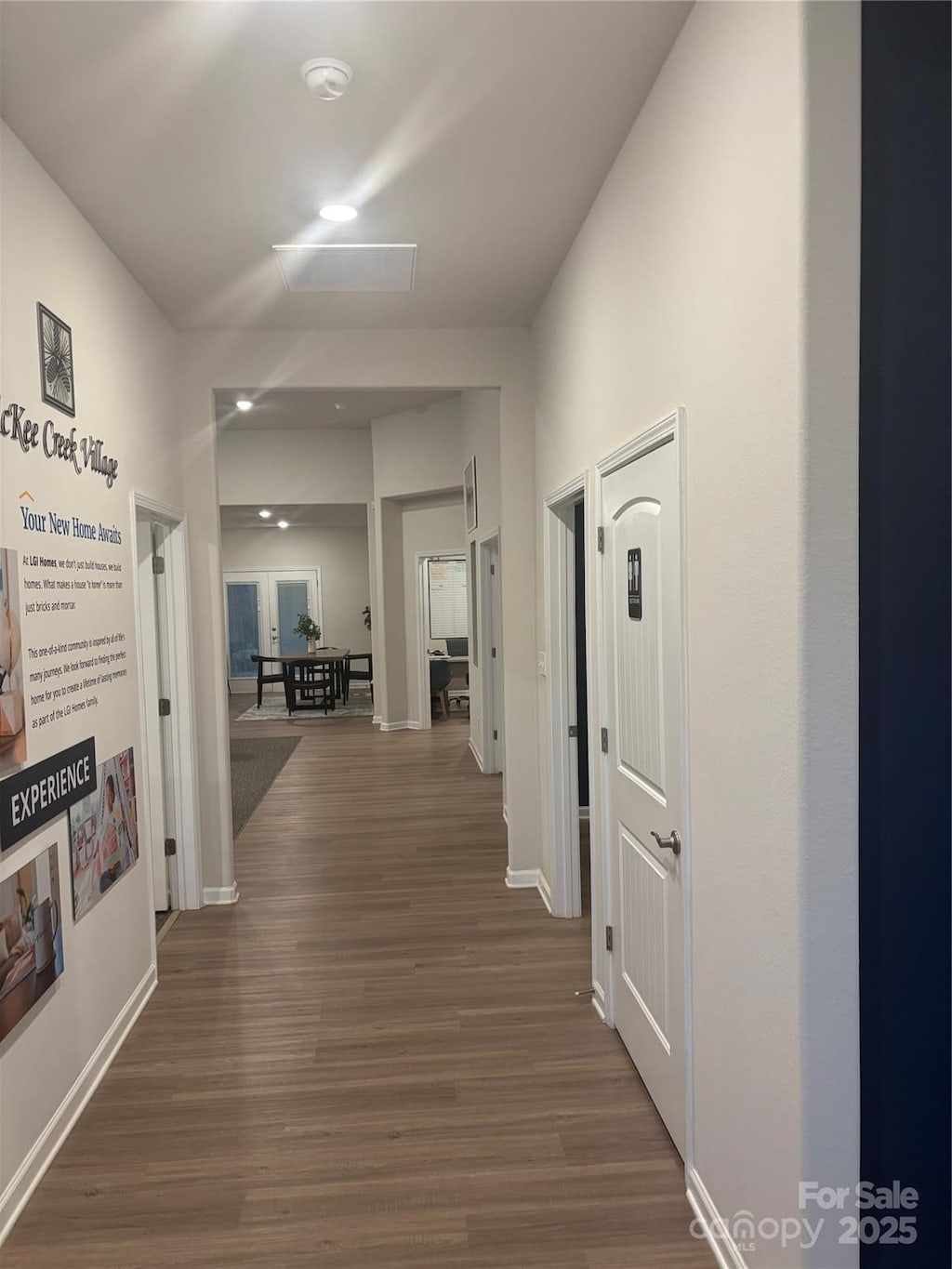 hall featuring baseboards and dark wood-type flooring