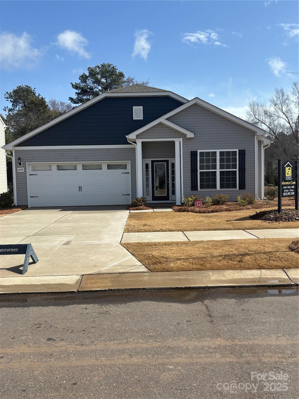 view of front of home featuring concrete driveway and an attached garage