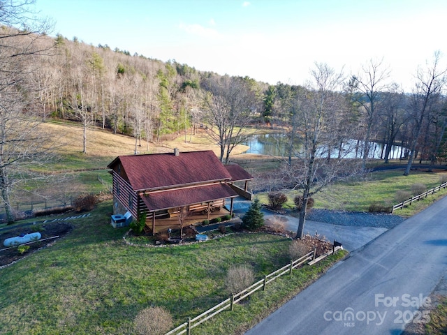 aerial view with a water view and a forest view