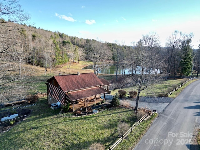 drone / aerial view featuring a wooded view