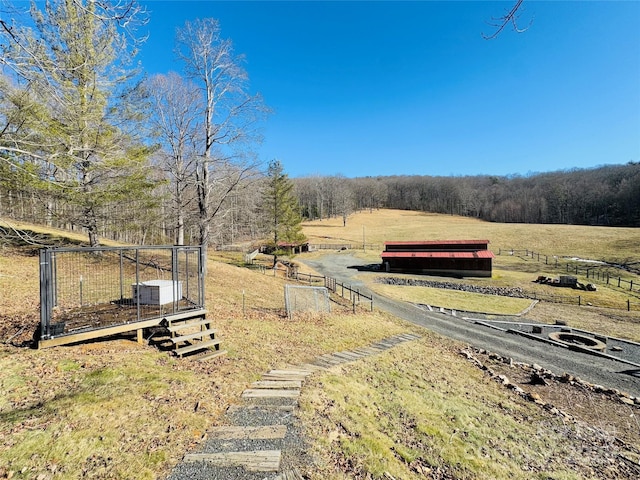 view of yard featuring fence and a rural view