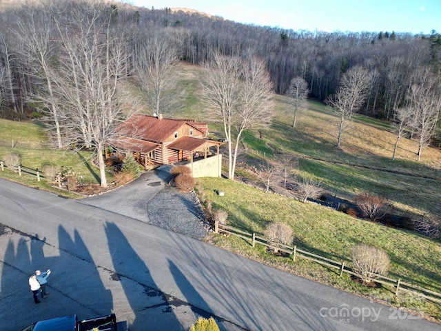 drone / aerial view featuring a view of trees