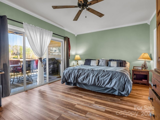 bedroom featuring ceiling fan, access to outside, wood finished floors, and ornamental molding