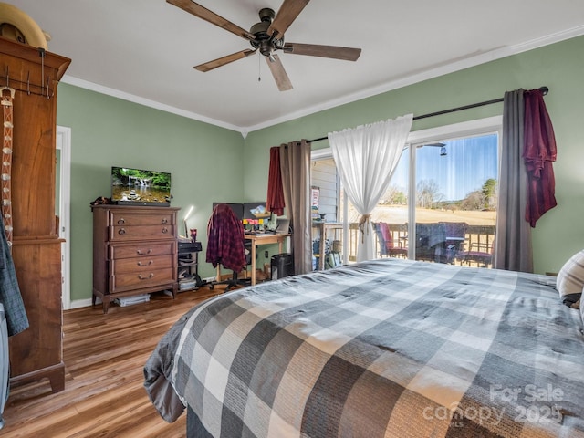 bedroom featuring a ceiling fan, wood finished floors, baseboards, crown molding, and access to outside