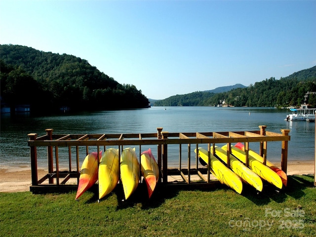 exterior space with a water view and a wooded view