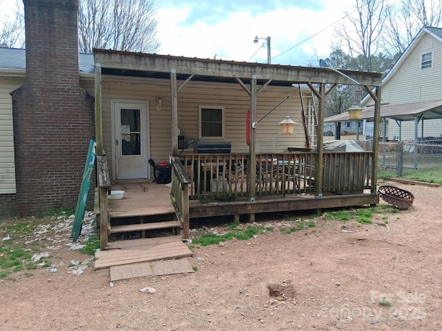 back of house featuring a deck and fence