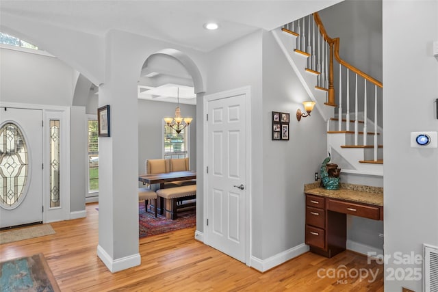 entryway with recessed lighting, baseboards, an inviting chandelier, and light wood-style flooring