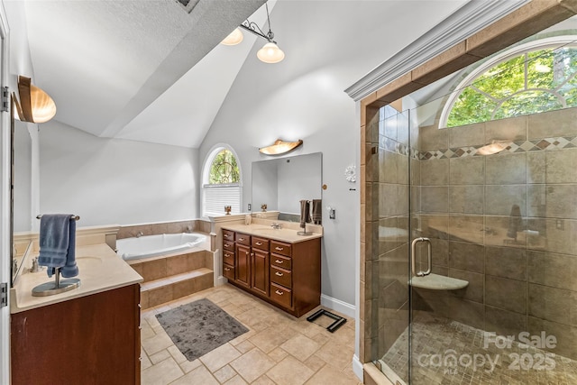 full bathroom featuring a stall shower, a sink, double vanity, lofted ceiling, and a bath