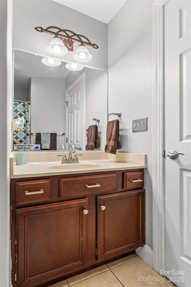 bathroom with tile patterned floors and vanity