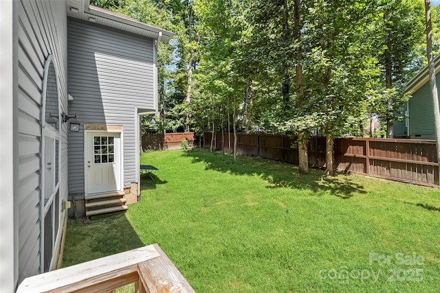 view of yard featuring entry steps and fence