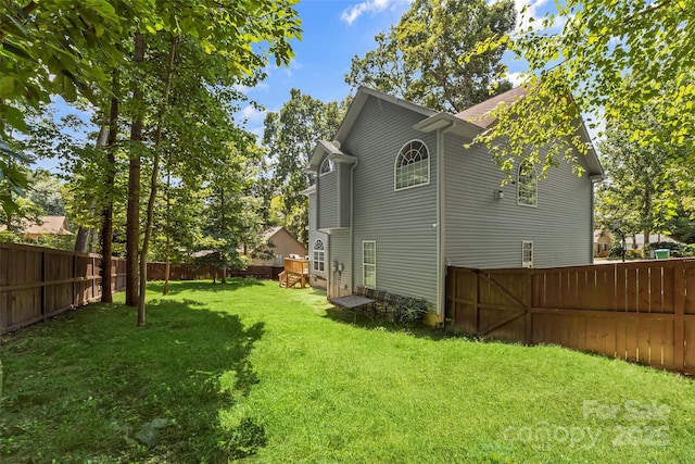 exterior space with a fenced backyard and a yard