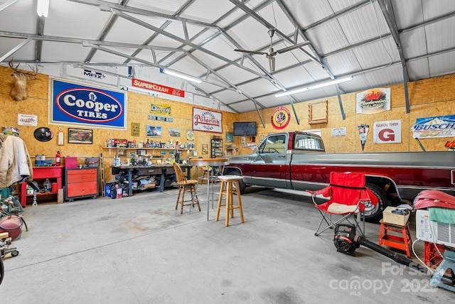 garage featuring a workshop area and metal wall