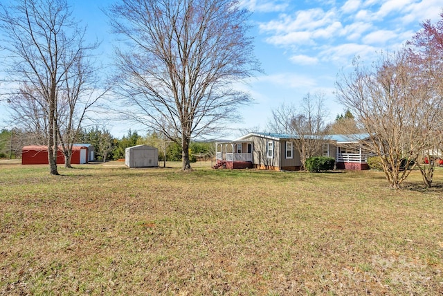 view of yard featuring a porch, a storage shed, and an outdoor structure