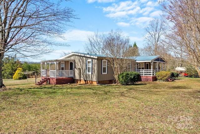 view of front of home featuring crawl space, covered porch, a front yard, and metal roof