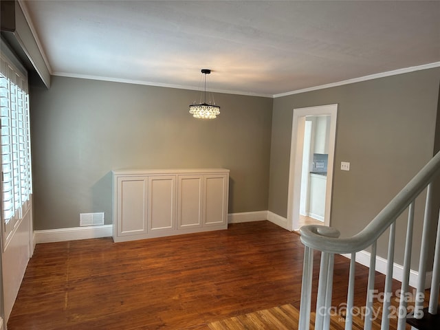 interior space featuring crown molding, stairs, visible vents, and dark wood-type flooring