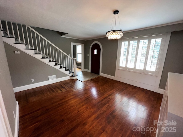 foyer with hardwood / wood-style flooring, stairs, and visible vents