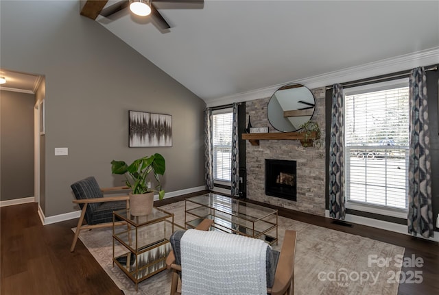 living room featuring wood finished floors, crown molding, a fireplace, and vaulted ceiling