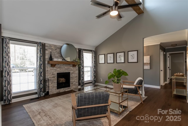 living area with a stone fireplace, wood finished floors, baseboards, and high vaulted ceiling