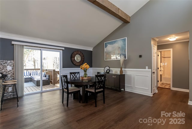 dining space featuring lofted ceiling with beams, a wainscoted wall, dark wood-style flooring, and crown molding