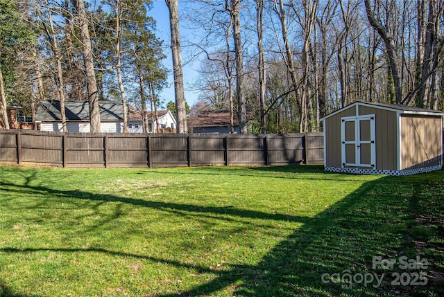 view of yard featuring a storage unit, an outbuilding, and fence