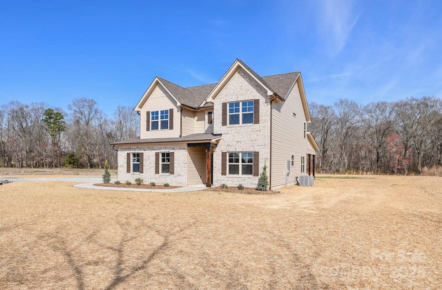 craftsman house with brick siding and cooling unit