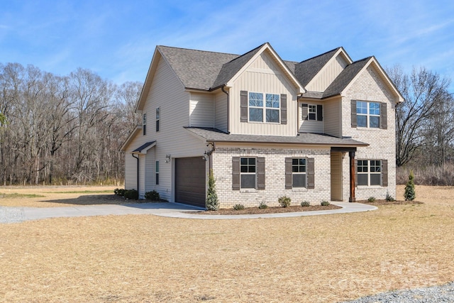 craftsman-style house with a shingled roof, concrete driveway, an attached garage, board and batten siding, and brick siding