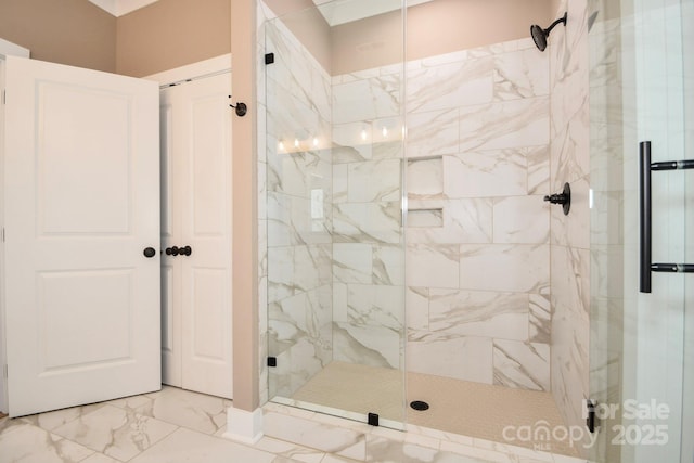 bathroom featuring marble finish floor and a stall shower