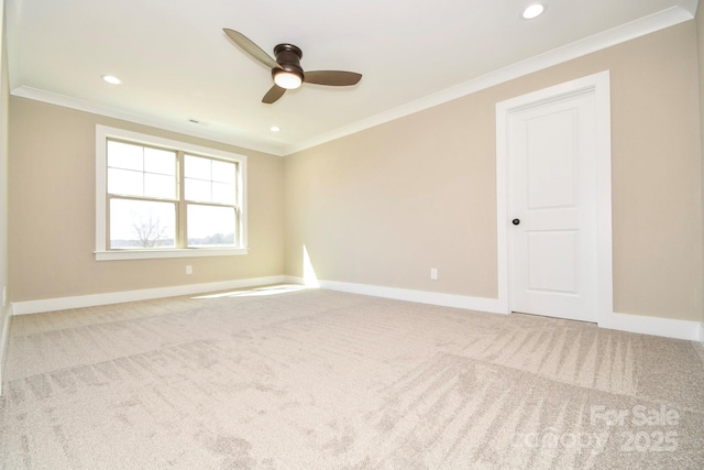 carpeted empty room featuring baseboards, ornamental molding, a ceiling fan, and recessed lighting