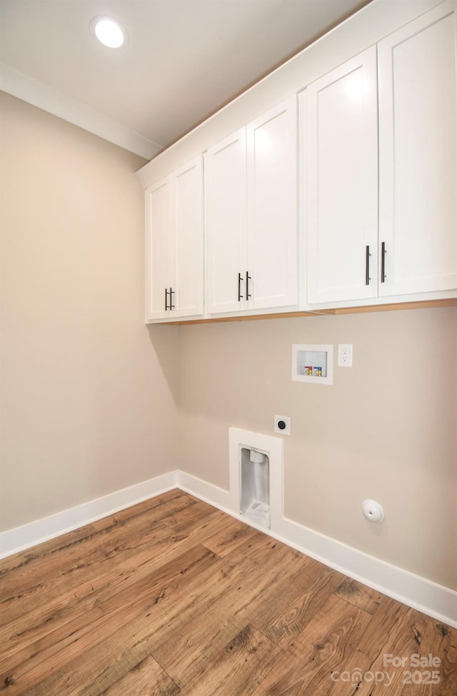 laundry area with washer hookup, cabinet space, electric dryer hookup, and baseboards