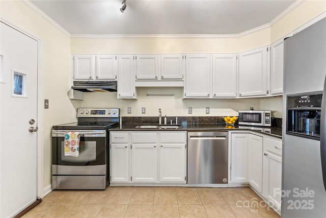 kitchen with light tile patterned floors, ornamental molding, stainless steel appliances, under cabinet range hood, and a sink