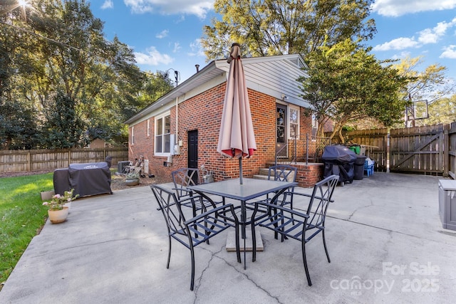 view of patio / terrace featuring fence private yard, a grill, and outdoor dining space