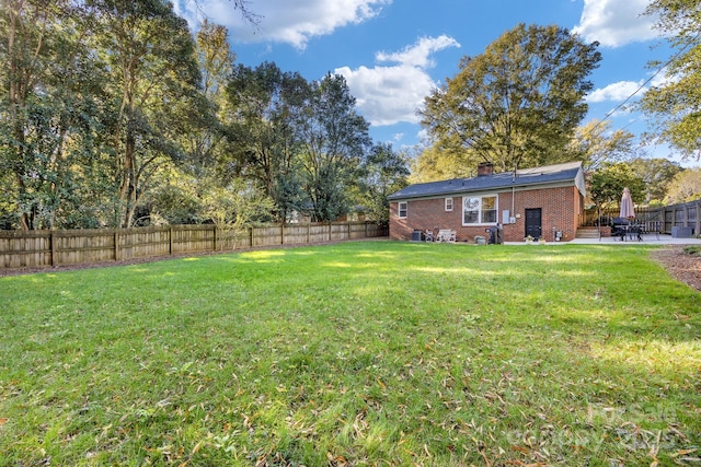 view of yard with a patio and a fenced backyard