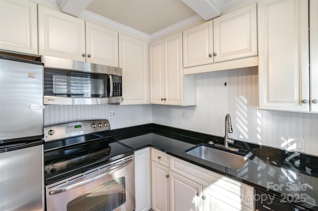 kitchen featuring appliances with stainless steel finishes, a sink, and white cabinets