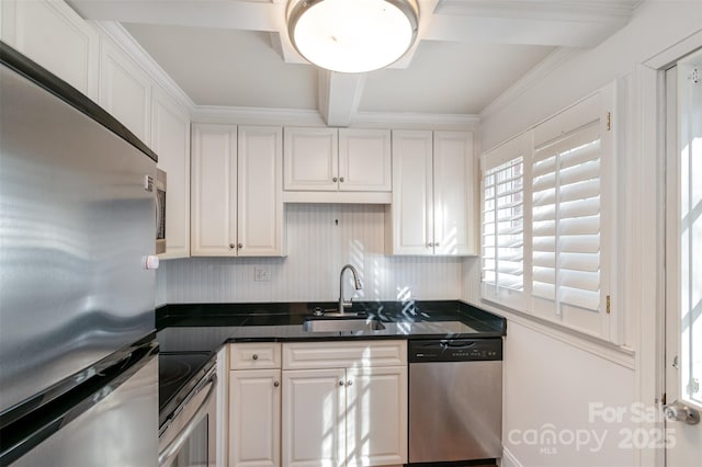 kitchen with appliances with stainless steel finishes, white cabinetry, a sink, and beamed ceiling