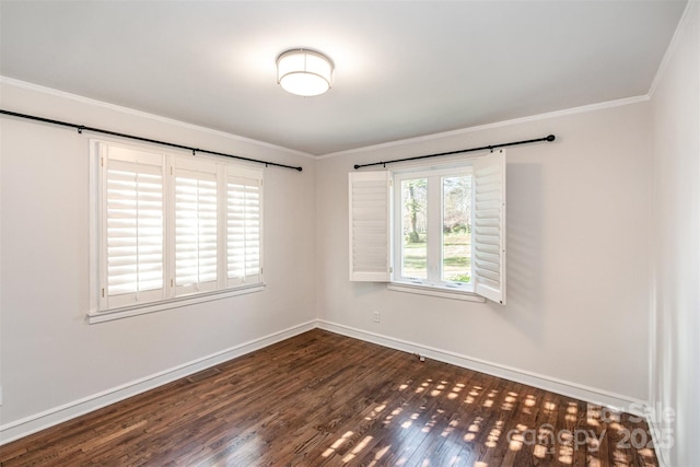 unfurnished room featuring dark wood-style floors, baseboards, and crown molding