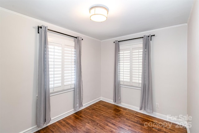 unfurnished room featuring a healthy amount of sunlight, baseboards, dark wood finished floors, and crown molding