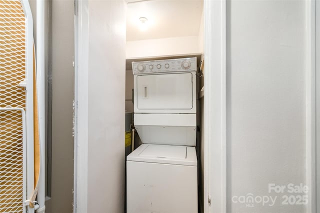 laundry area with stacked washer and clothes dryer