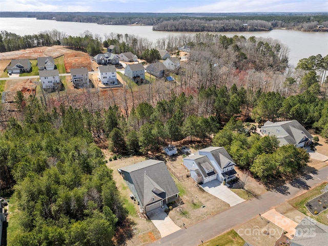 drone / aerial view featuring a water view and a forest view