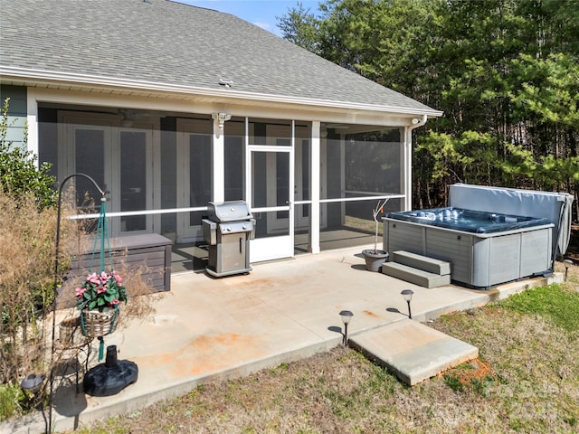 view of patio with a sunroom, a hot tub, and grilling area