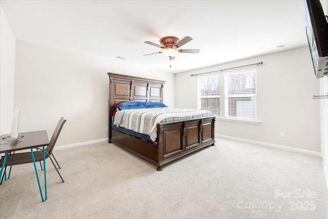 bedroom featuring light carpet, ceiling fan, and baseboards