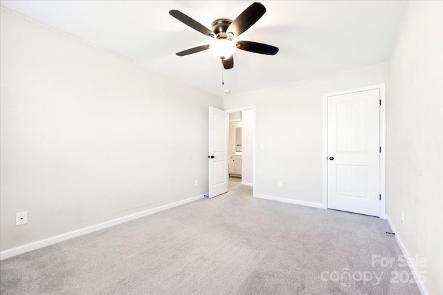 unfurnished bedroom with carpet floors, a ceiling fan, and baseboards