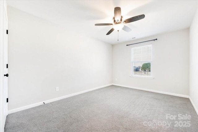 empty room featuring carpet floors, baseboards, and a ceiling fan