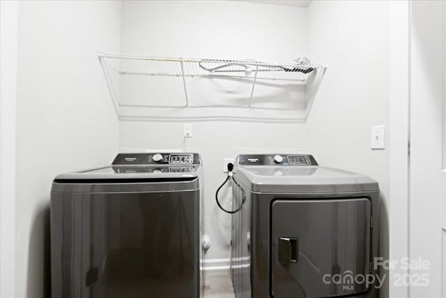 clothes washing area featuring washing machine and dryer and laundry area