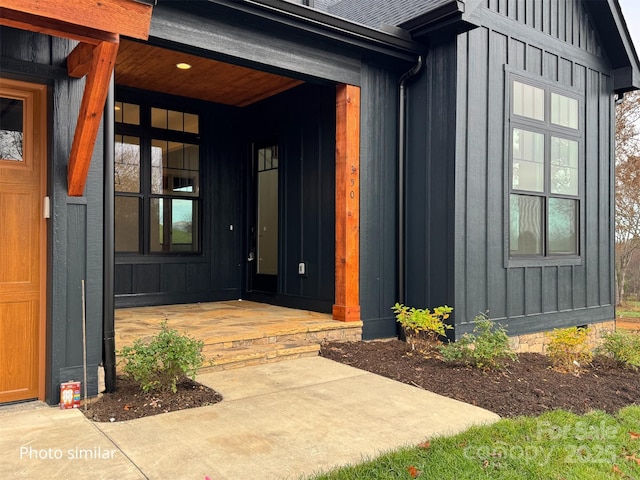 doorway to property featuring a porch and board and batten siding