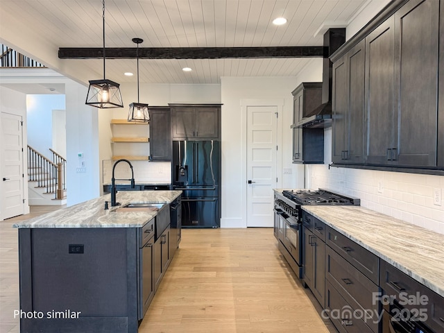 kitchen with open shelves, light wood-style flooring, a sink, wall chimney range hood, and black appliances