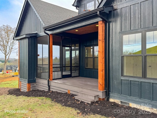 exterior space with board and batten siding and roof with shingles