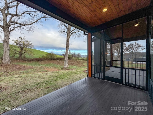 wooden deck with a sunroom